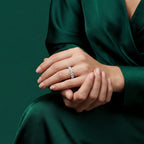 Woman wearing 18k white gold diamond riviera eternity ring on hand