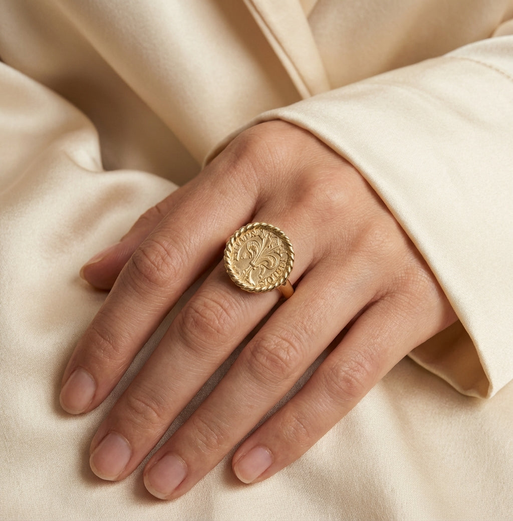 Woman wearing 18k gold Florentine coin ring with rope border