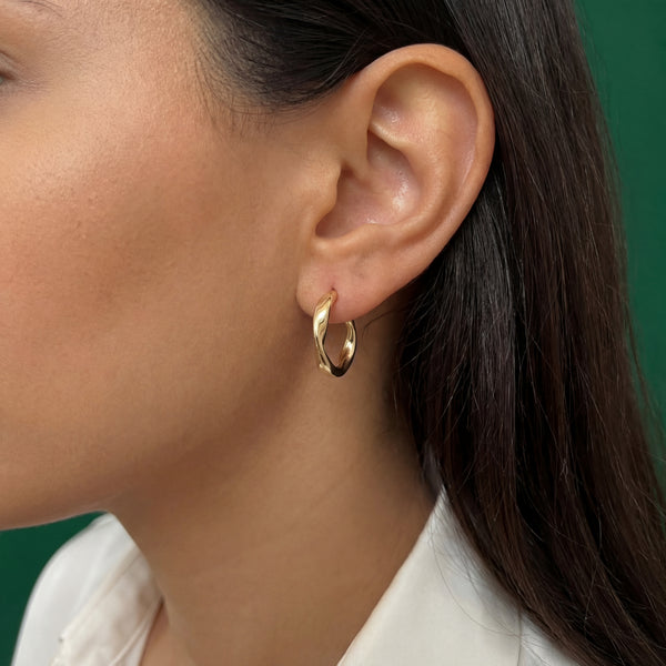 18k gold sculptural wave hoop earrings worn